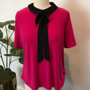 CeCe Fuchsia top with black collar and tie.